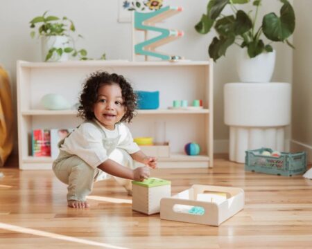 little boy playing with lovevery Montessori toys