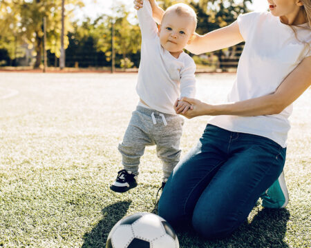 mom with son playing soccer