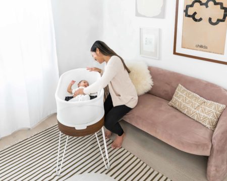 mother looking at baby in snoo working on how to wean from snoo
