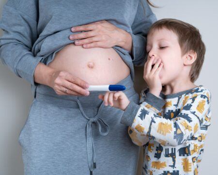 pregnant woman shows her young son a positive pregnancy test concept of happy family t20 7y8xy6